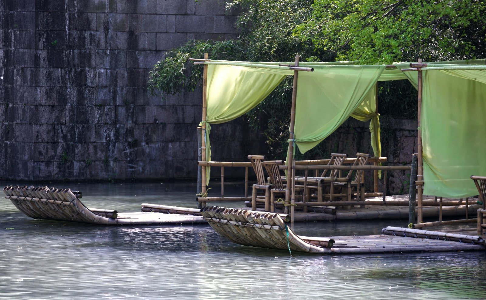 a couple of small boats floating on top of a river